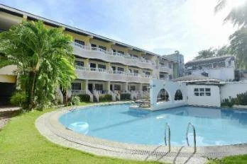 Resort courtyard with a swimming pool and palm trees