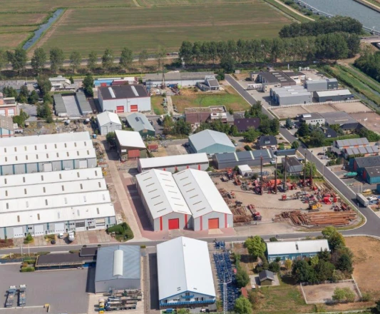 Aerial view of an industrial area with warehouse sheds and yards